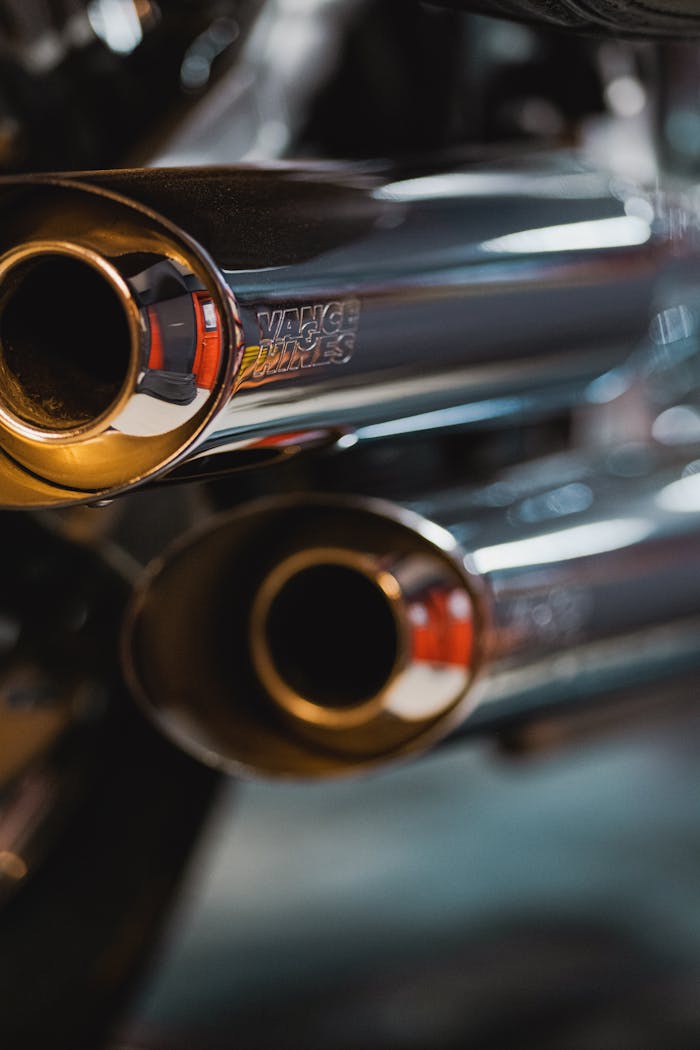 Detailed view of chrome motorcycle exhaust pipes with Vance & Hines branding.